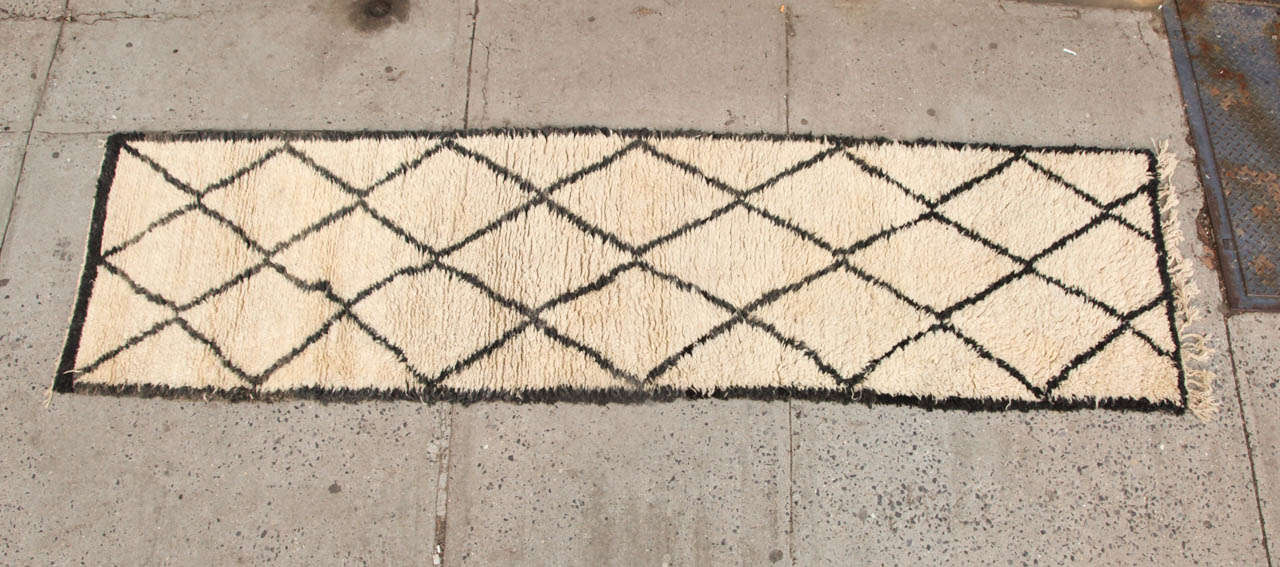 Decorative vintage Beni Ourain rug from Morocco. 100% wool. It is hand loomed. Deep wool pile in a cream color with bold , geometric pattern. This is a runner. 12' x3'1