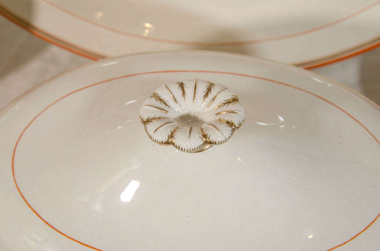 English Wedgwood Group of Platters, Dishes and Tureens with Orange and Gilt Borders