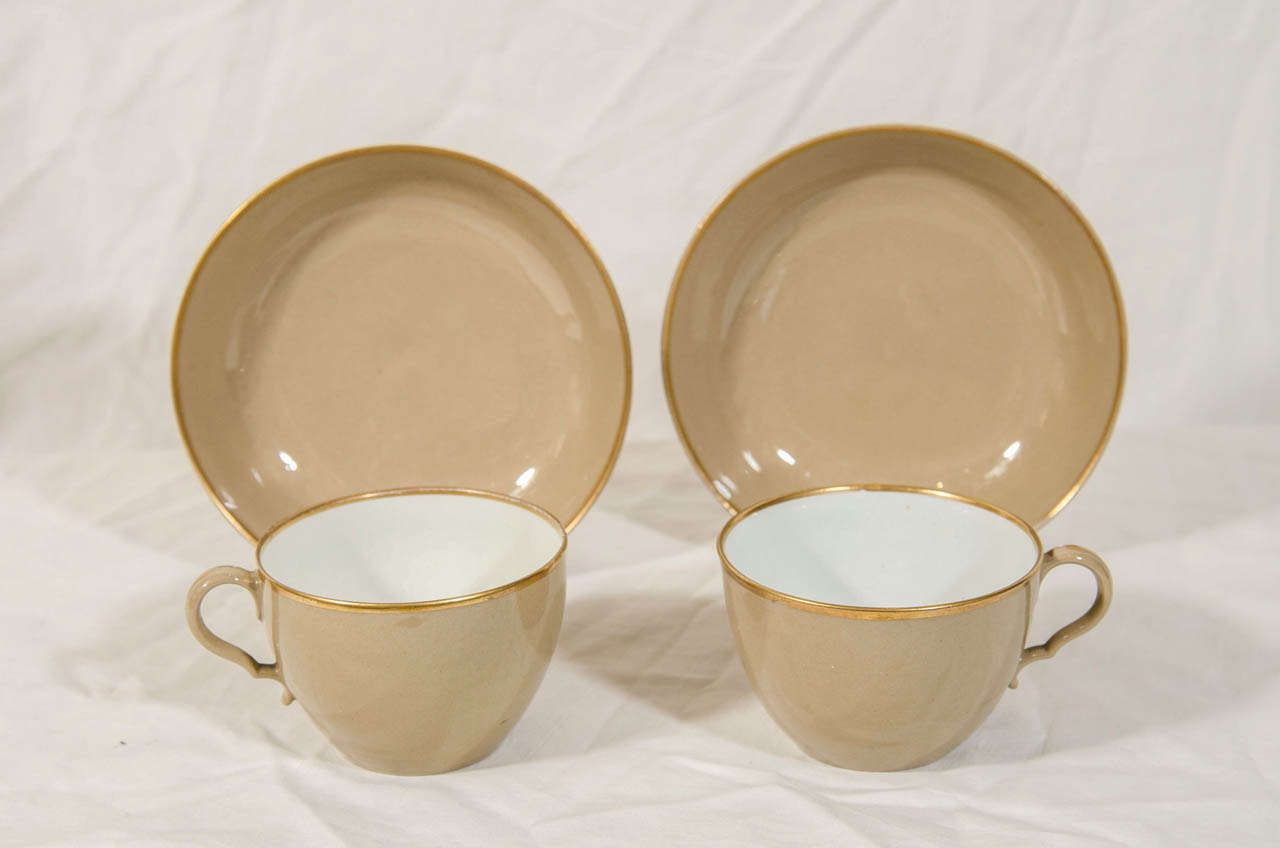A set of drabware tea cups and saucers with gilt edges made in the
early 19th century. Unlike other colored wares which have a white body painted in various colors drabware is made from dark clay, resulting in its deep, rich color.
 
