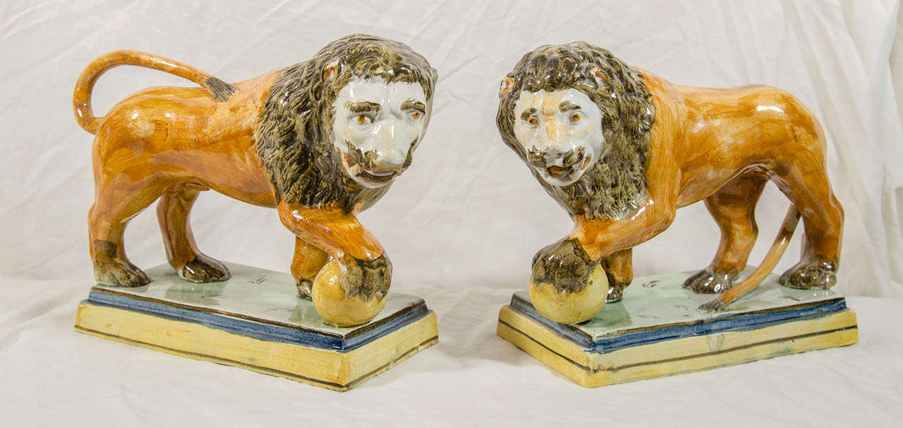 A pair of Staffordshire pottery lions modeled on the Renaissance Medici Lions in Rome. Their naive painting creates a typical Staffordshire contradiction between their serious classical modeling and their naive painting. The lions symbolize courage,