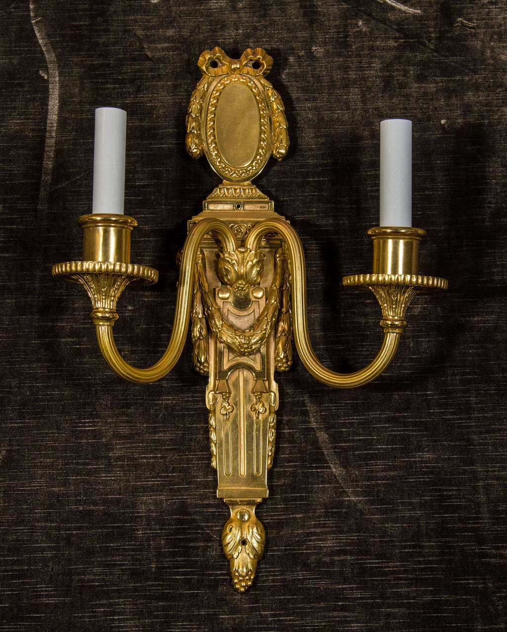 A pair of  antique American Louis XVI style gilt bronze double-light wall sconces of fine quality embellished with ribbons and wreaths by E. F. Caldwell.