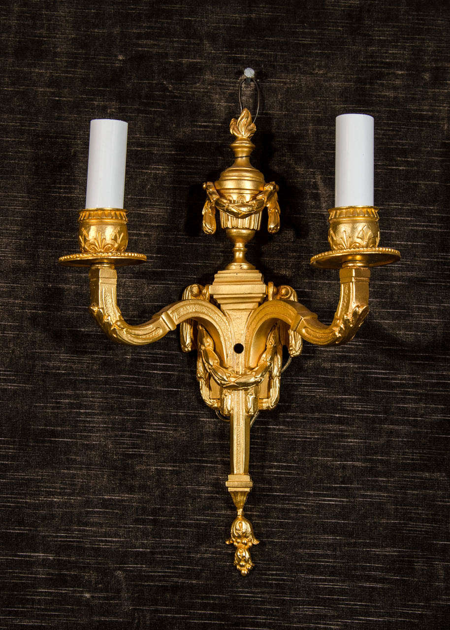 Pair of fine antique French Louis XVI gilt bronze two-light wall sconces.