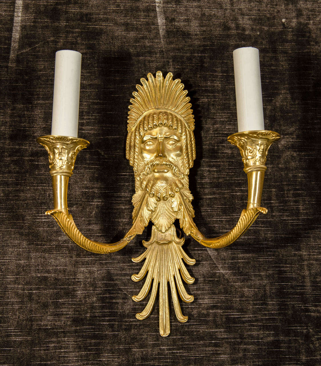 A set of eight superb French Empire style gilt bronze figural double light wall sconces of great quality embellished with fine figural masks of neoclassical men.