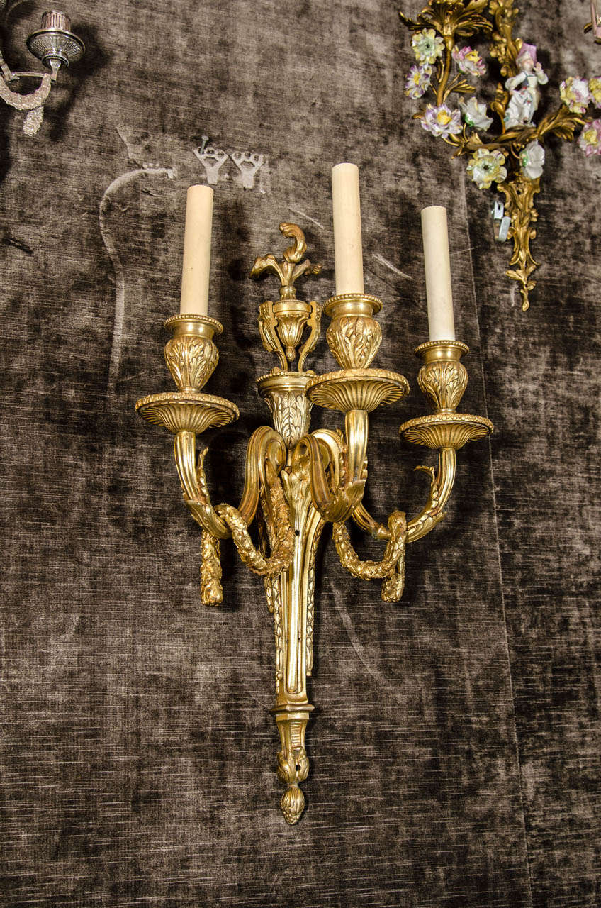 A pair of antique French Louis XVI style gilt bronze wall sconces of great quality.