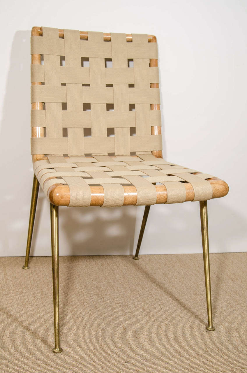 A T. H. Robsjohn-Gibbings webbed Chair, 1950’s, with slender brass legs, Priced individually. Please note one chair is 35