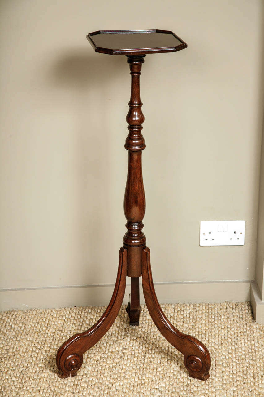 A Dutch mahogany tripod torchere, third quarter of the 18th century, on a baluster column supporting a rectangular dished top. With down-swept legs terminating on scrolled feet. Nice glossy finish