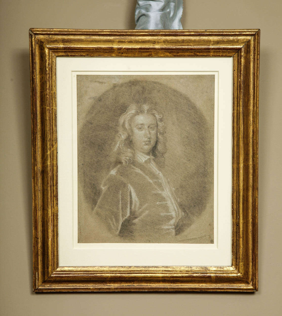 Portrait of a Gentleman, Circle of Sir Godfrey Kneller c.1720.
Chalk on grey paper; 10 by 8 in (25.5 x 20 cm) held in a giltwood frame, total size 13.5 x 15.5 in.
Provenance: August Grahl (1791-1868)  This intriguing portrait drawing was