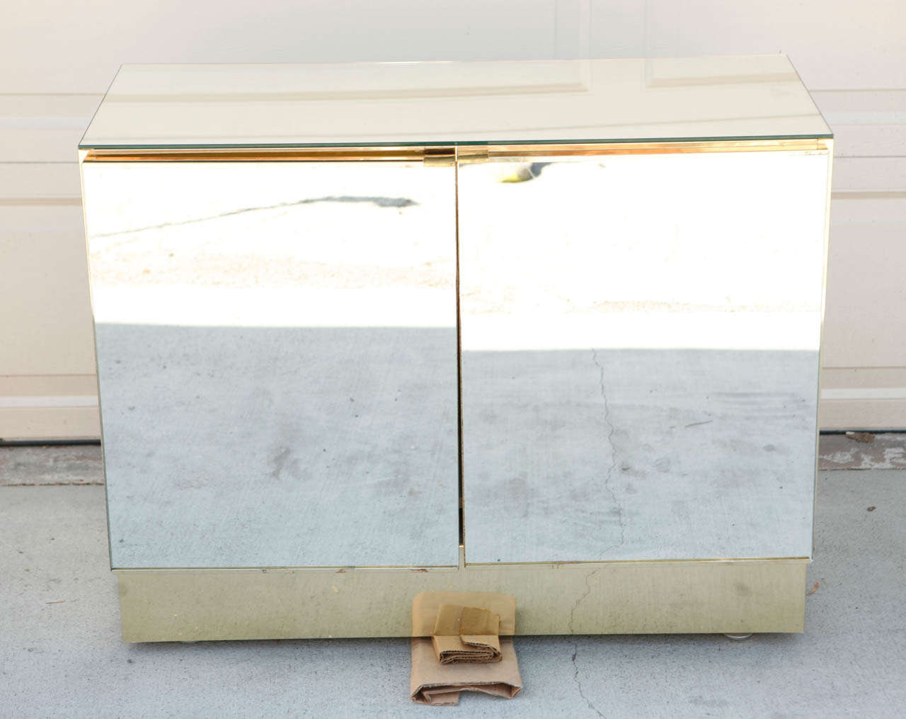 Pair of Ello brass smoked mirror cabinets.  Cabinets open with two-tiered shelving for additional storage.