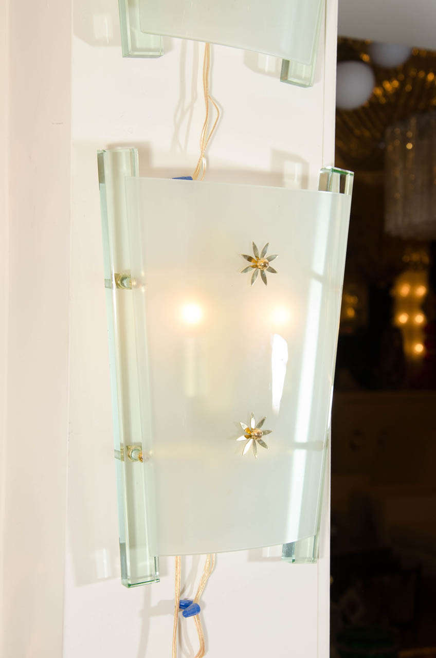 Pair of frosted Murano glass demilune sconces with decorative brass details.
