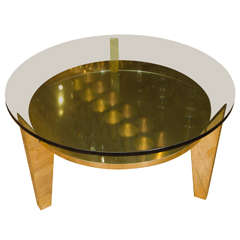 Brass and glass side table featuring three angular leg design