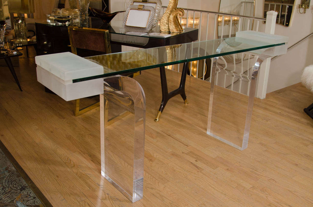 Lucite console table with inverted waterfall base and glass top.