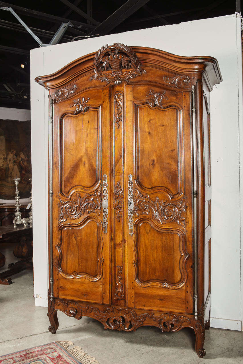Everything on this armoire flows without interruption in a refined elegance.  All of its hardware is original and its condition has been carefully conserved over the centuries.  The interior is exceptional compared to other armoires that we usually