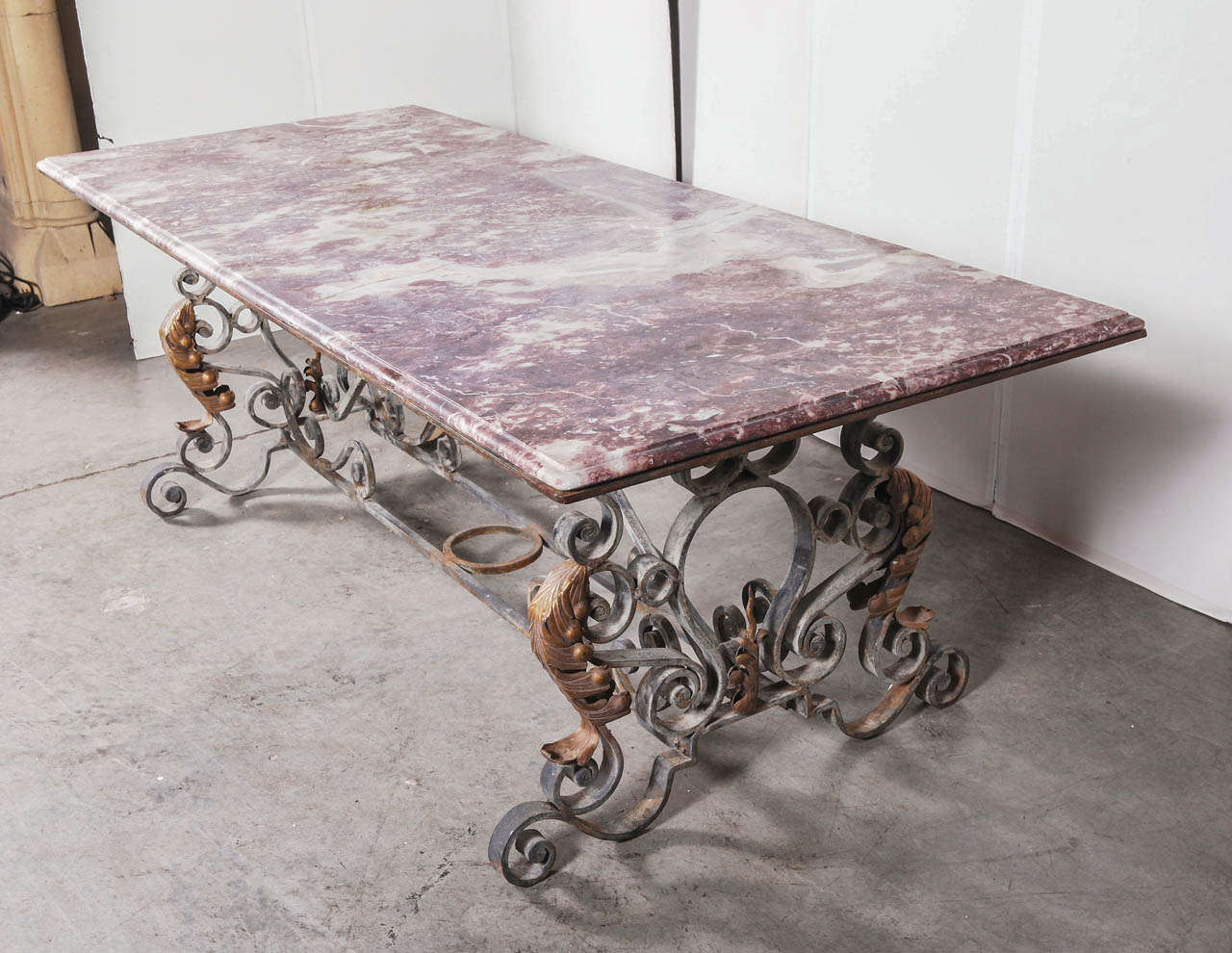 This stunning Period French Napoleon III table has a hand forged, thick iron base and its original marble top.  This versatile table can be used as dining tables, large entry hall tables and garden room tables, and are suitable for inside or
