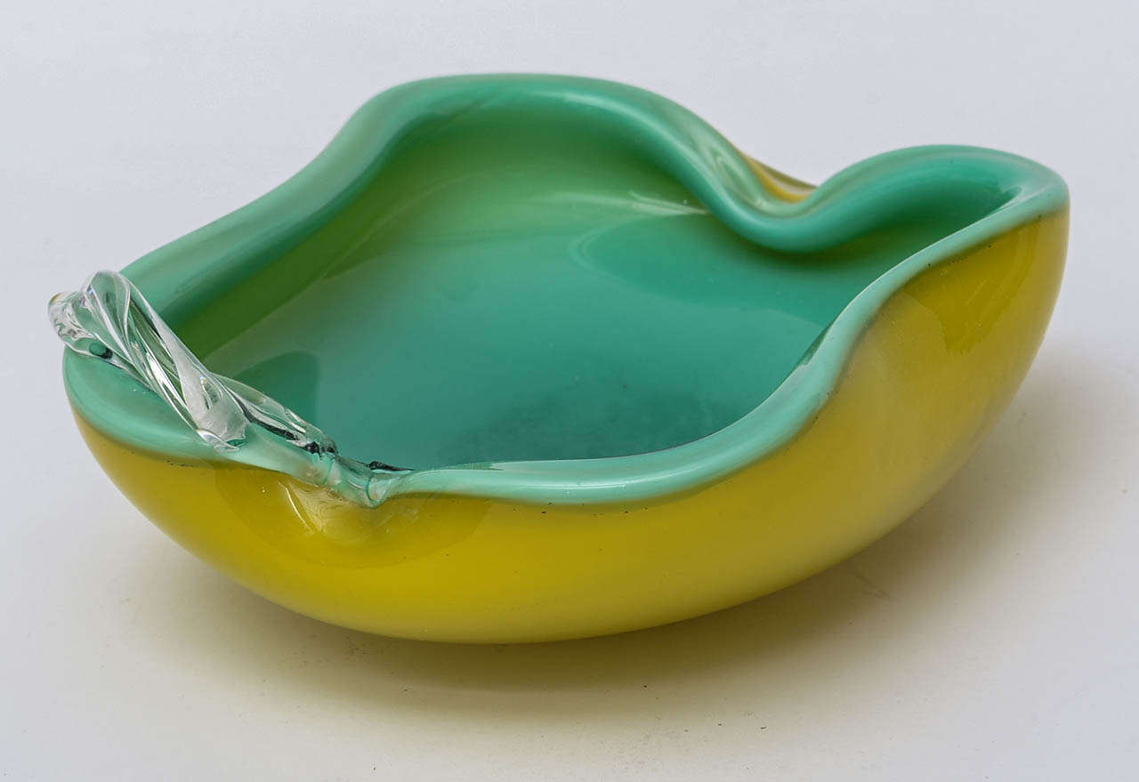 Two beautiful colors meet.. with an clear apple appendage ....italian Murano glass bowl has the chartreuse outside with the turquoise green inside...
There is a clear glass over that...Lovely Murano glass bowl !!!!