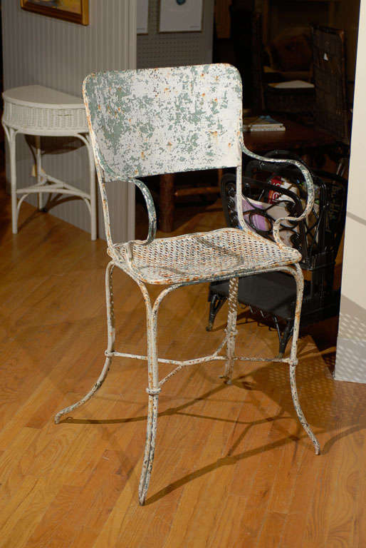 This is a fantastic chair.  It is a tennis court chair from France.  The layers of paint have given the chair a wonderful patina.  The chair is comfortable.  
 
Dearing Antiques was established in 1977.