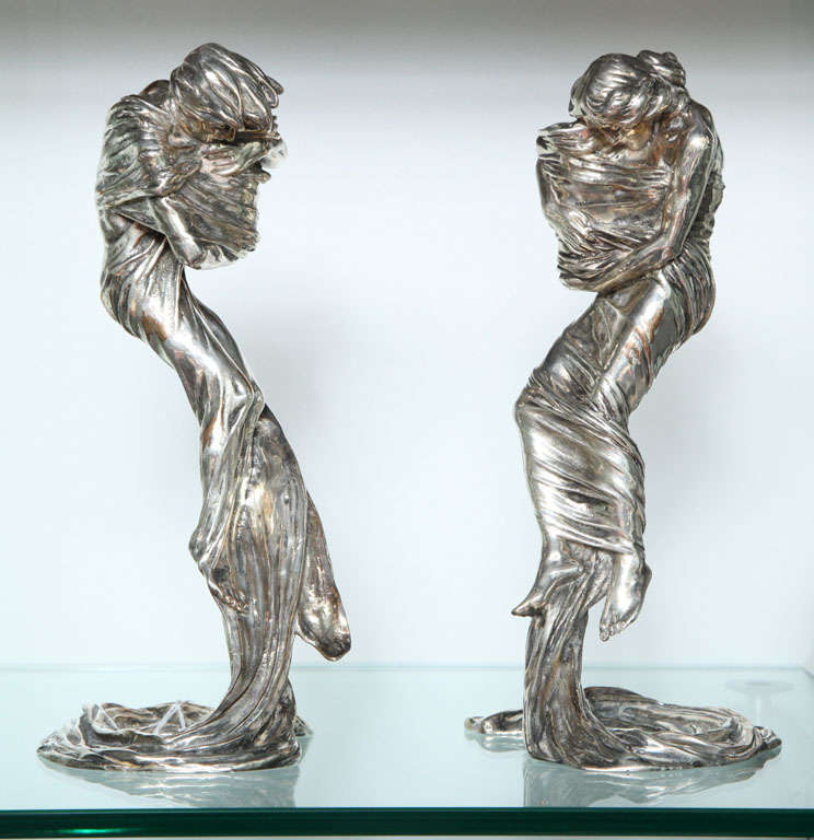 A pair of figural gilt bronze candlesticks 