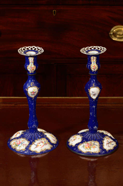 An unusual and large pair of Battersea enamel Georgian candlesticks.