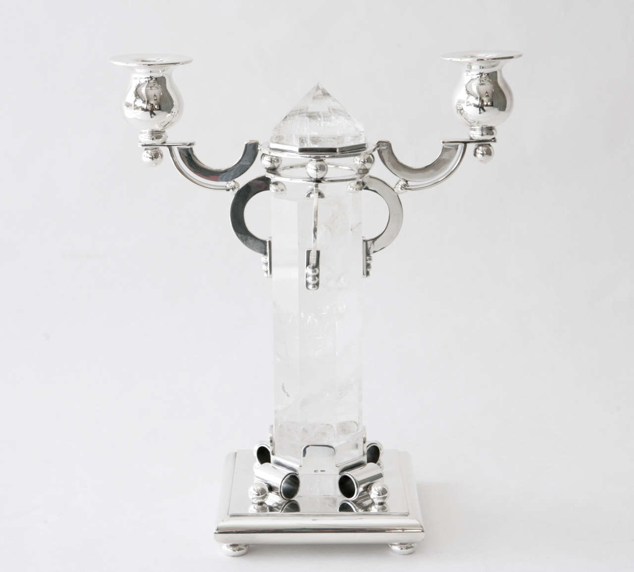 A stunning two arm sterling silver candelabra with a rock crystal obelisk at its center by Devecchi. Stamped on the underside with the Devecchi mark, 