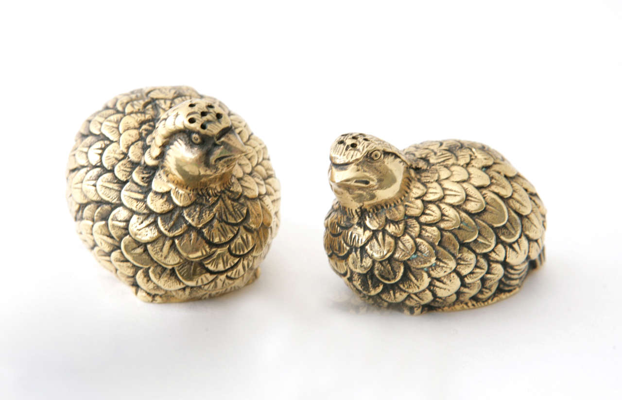 A chic pair of brass salt & pepper shakers by Gucci. The quails are quite detailed, down to the texturing in their feathers. Marked on the bottom 