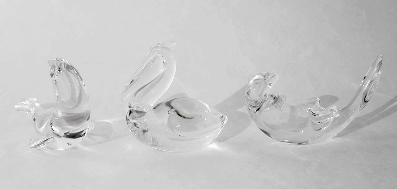 A whimsical trio of crystal animals by Steuben Glass that includes a seal, a pelican and an otter. Dimensions given below are for the seal, designed in 1962 by glass artist George Thompson, which can be purchased individually for $500. The pelican,