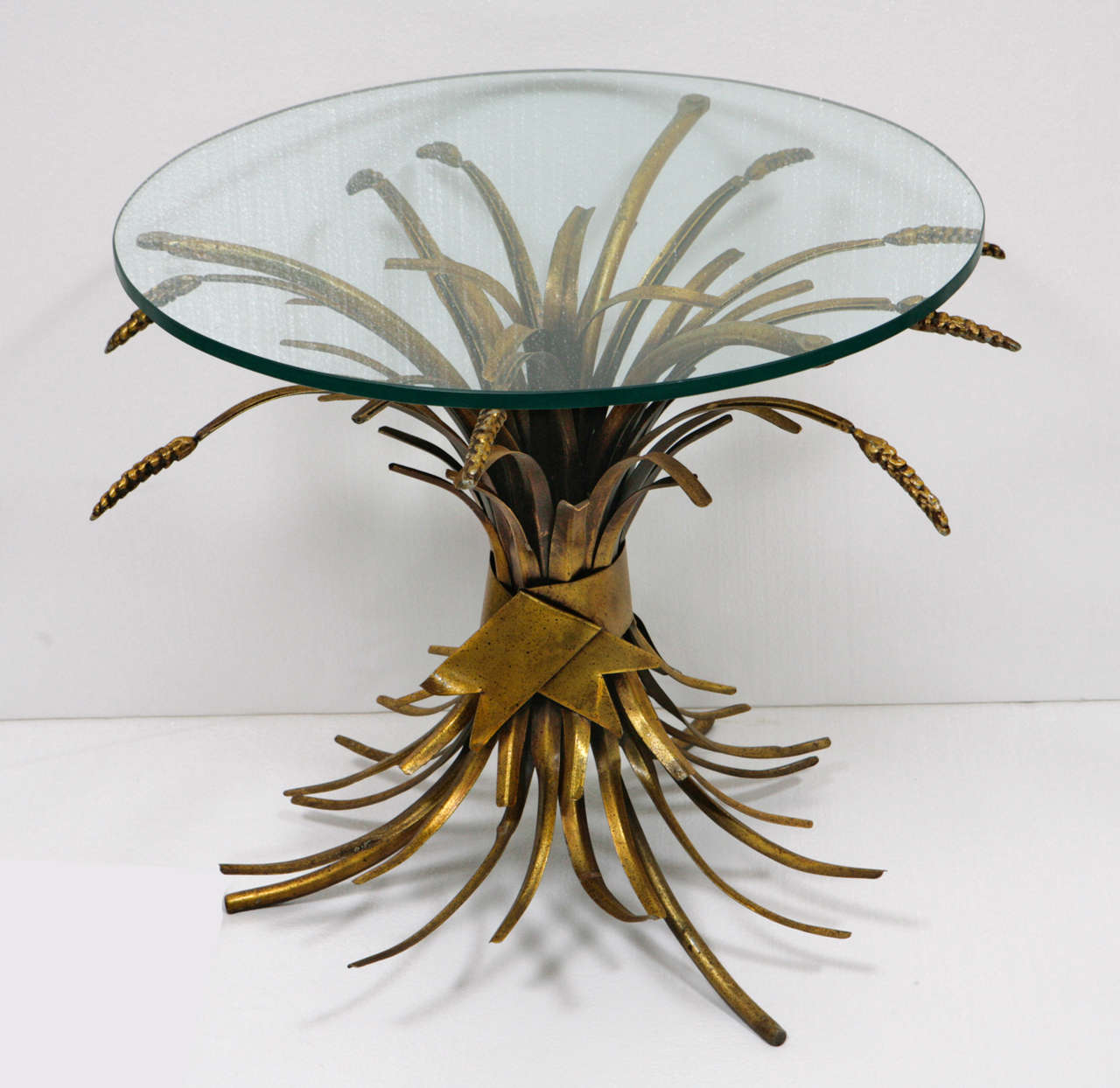 Mid century table in the form of a sheaf of wheat tied with a bow. Gold painted finish with some distress to the finish. 3/8