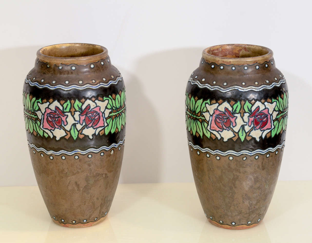 Brown stoneware ceramic with pastel glazed flowers decoration.