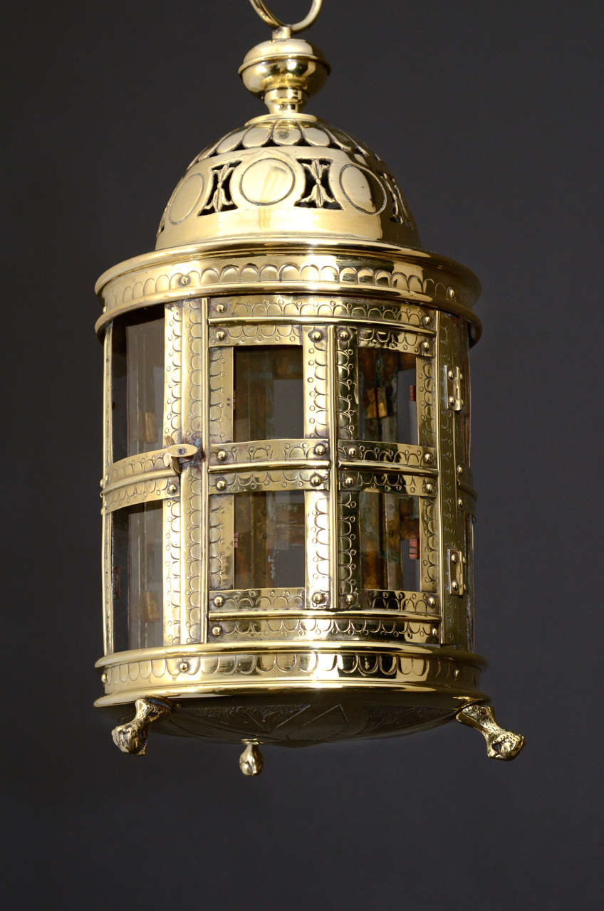 Pierced and Engraved Dutch Brass Lantern with Paneled Glass and Paw Feet for Table Light Use.