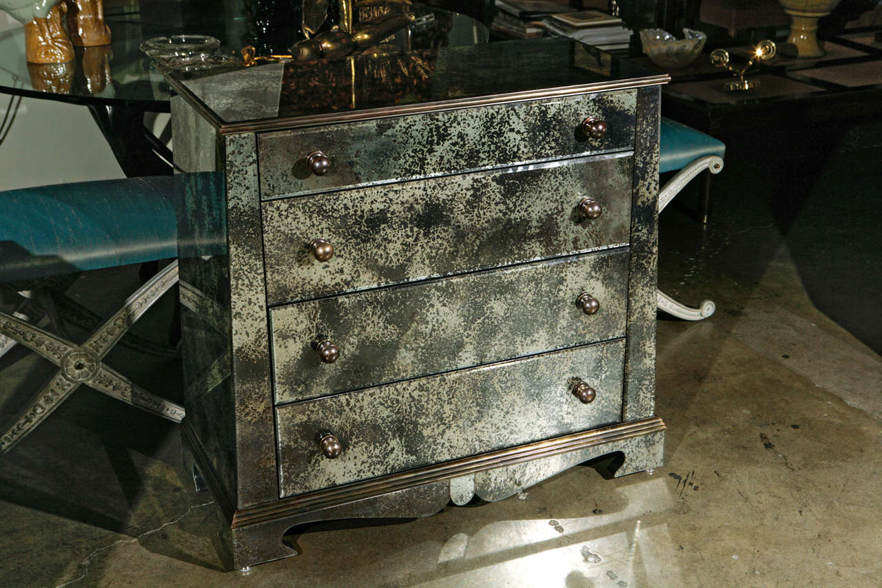 Paul Marra antiqued mirror chest of late 19thc European style. Antique beveled mirror glass, painted interior and back, brass handles, French clad wood molding in brass. Inquire,  by order.
.