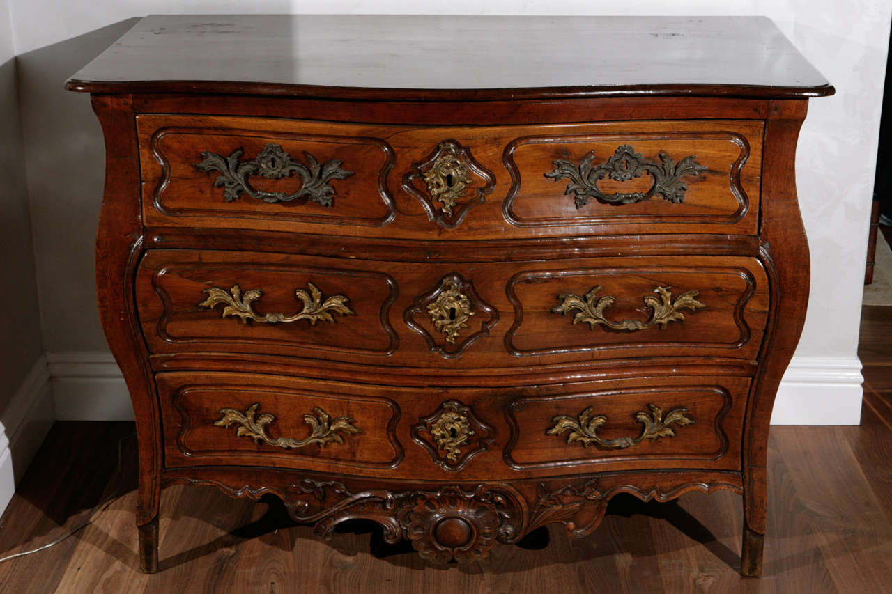 Late 18th century French Carved Walnut Serpentine Commode with three Drawers.