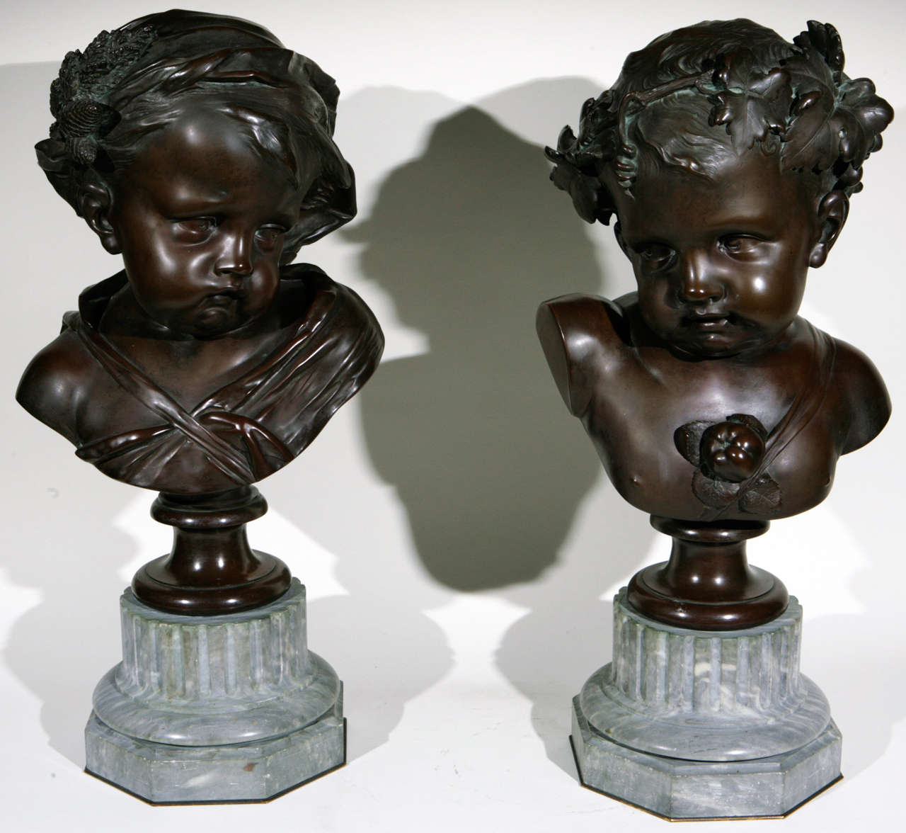 Pair of Very Fine 19th c. French Bronze Busts of Children on Original Gray Marble Bases. The base measurement is 8 inches.