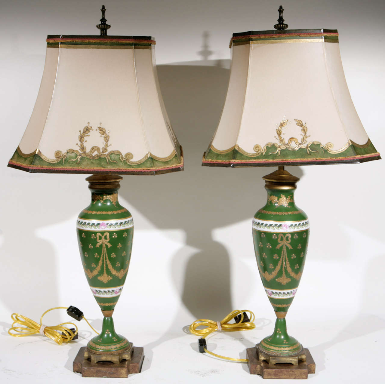 Pair of 19th c. Limoges Porcelain Urn Lamps. The Shades are included and are Hand Made of Parchment Paper. They are Hand Gilded and Decorated. The lamps have been newly wired. The measurement to the top of the finial is 26 inches. From the estate of