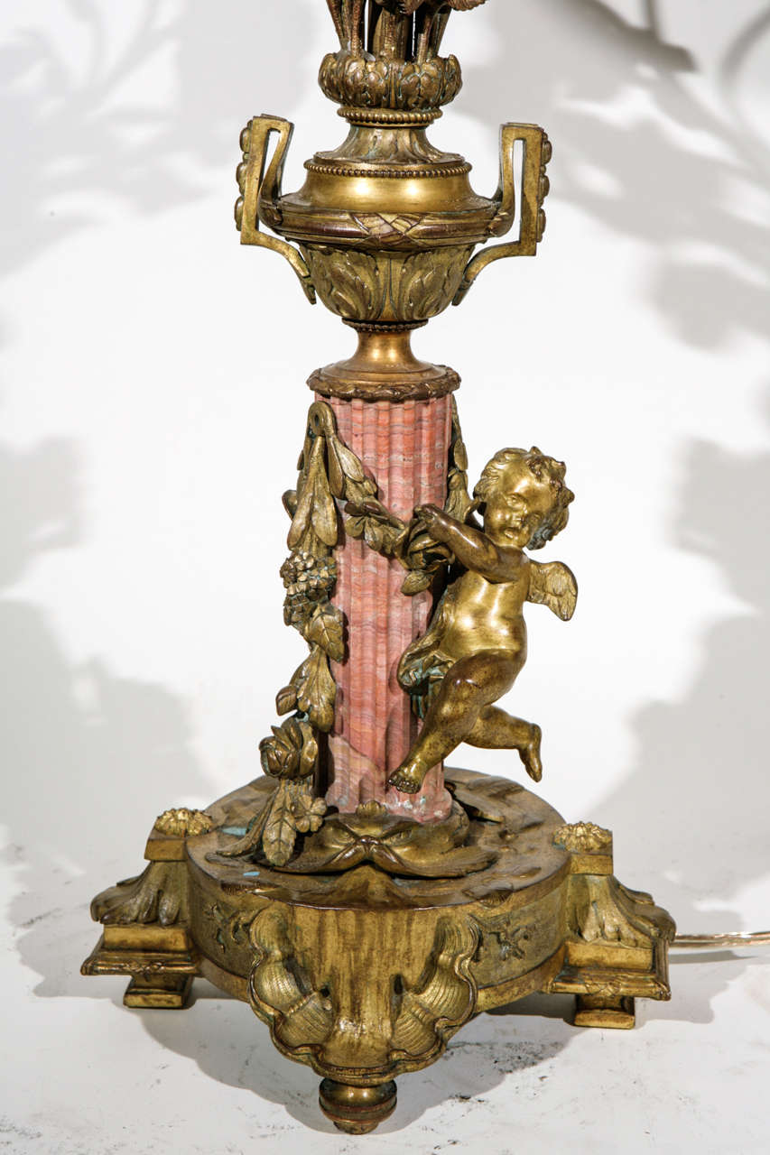 Pair of Very Fine 19th c. French Bronze and Coral Marble Candelabras Converted to Lamps. They have Cherub and Rose Carved Bronze Motif. The Shades are included and are Hand Made of Parchment Paper. They are Hand Gilded and Decorated. The measurement