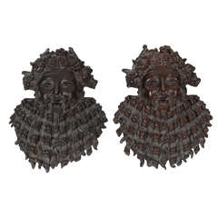 A pair of bronze Bacchus masks.