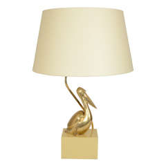 Brass Pelican Lamp on Cream-Colored Plastic Base