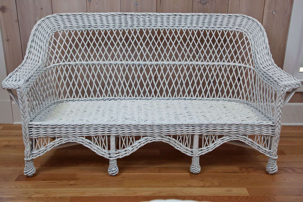 Bar Harbor Wicker Sofa with woven seat and pineapple feet.  Substantial and sturdy piece.

Overall width 70