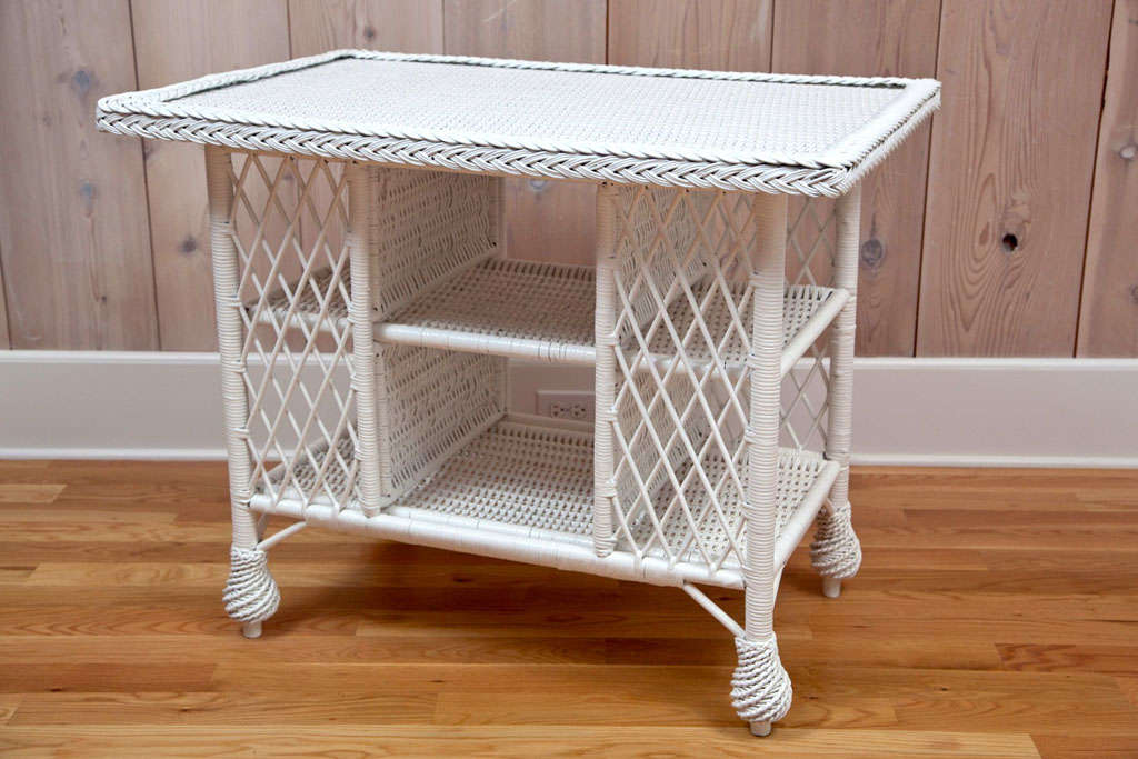 Antique Wicker library table with removable braided edging to accommodate a glass or fabric covering of woven top.