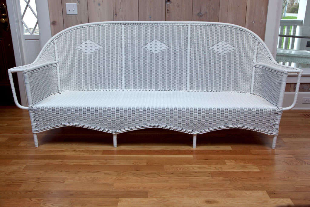Antique extra long, tightly woven reed sofa with diamond pattern in the back. Matching side chairs as well as desk and chair available under separate listings. This sofa is in excellent condition. Matching pieces are listed separately.