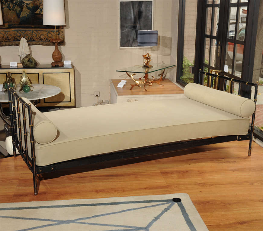 A sleek faux-bamboo leather and brass-detailed daybed by Jacques ADNET (1900-1984)