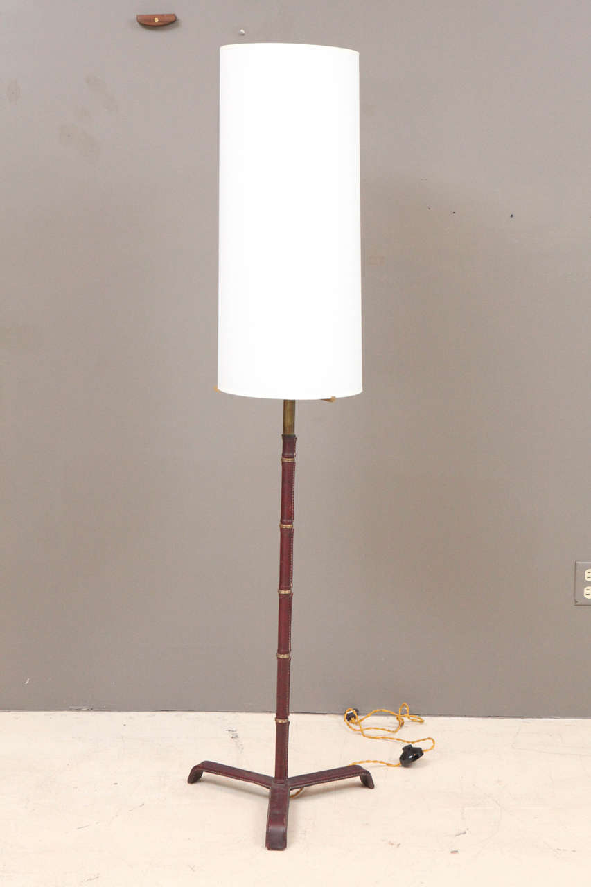 Leather clad floor lamp by Jacques Adnet.
