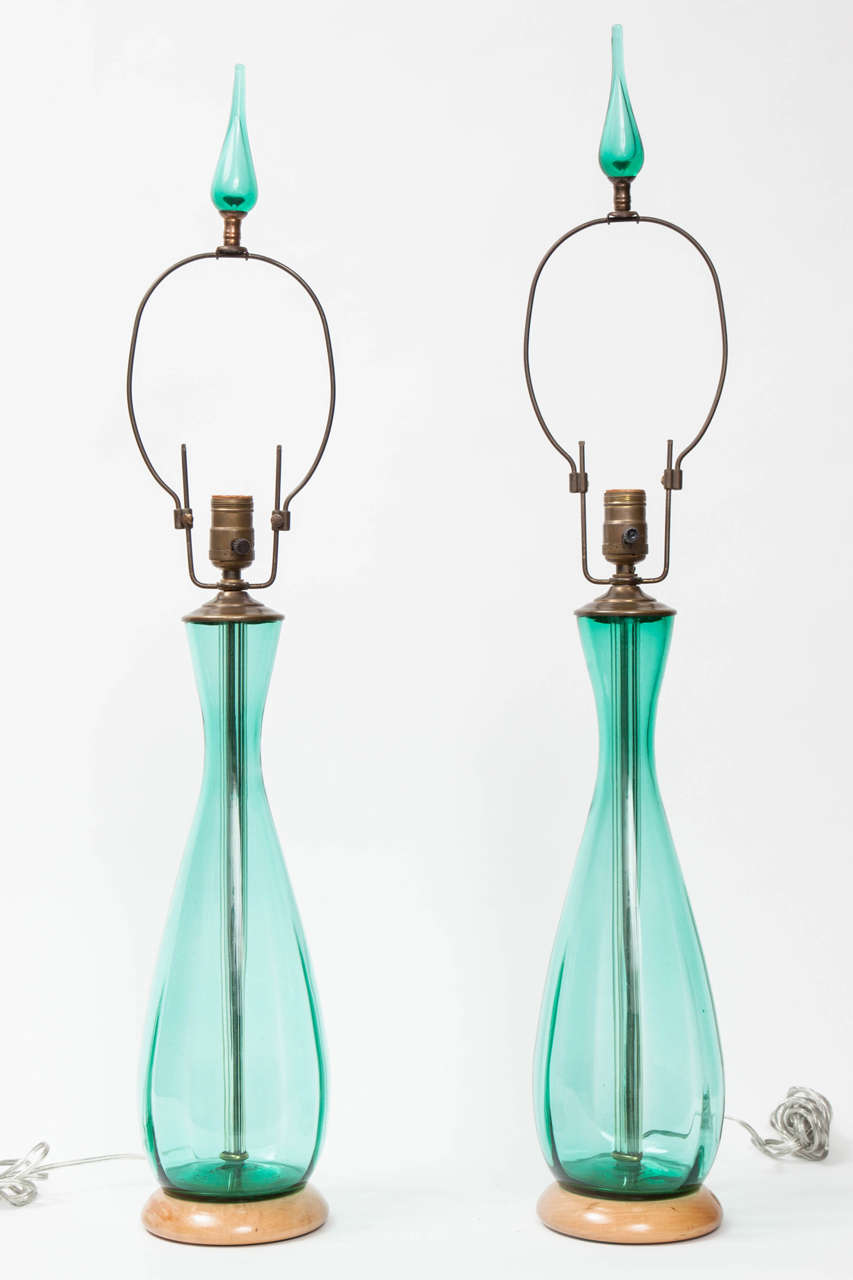 Pair of Blenko Glass table lamps, each of baluster form, with a green ground, raised on a circular foot.
Height overall 33 inches.

