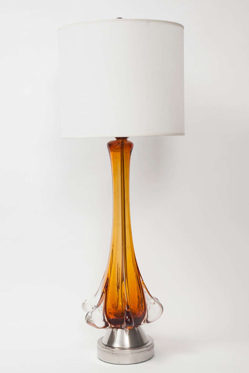 Mid Century classic Murano glass lamps in  Amber with clear glass overlay and fins sitting on satin nickel bases. Due to them being hand blown pieces, one lamp is 1/2 inch taller. Rewired with new sockets.