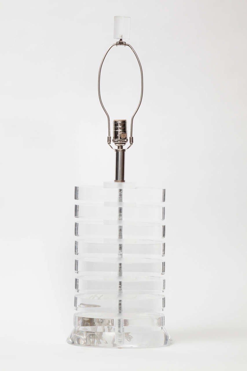 Pair of stacked oval Lucite disc lamps in the style of Karl Springer.