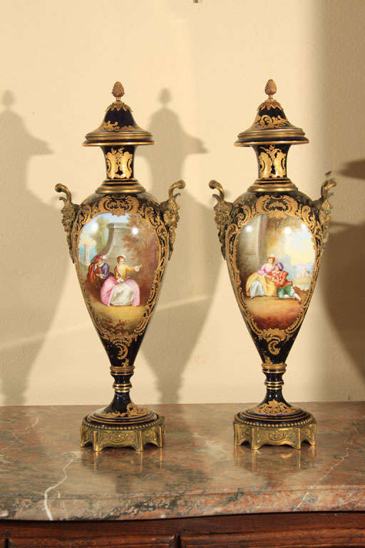 Pair of Chateau De Tuileries Bronze Urns. Marked with blue Louis Philippe monogram. Pine cone finial, gilt floral motif.