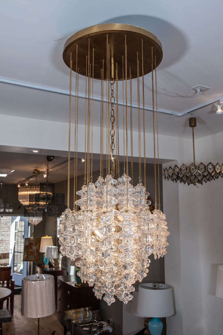 A stunning and classy Murano 4 light pendant with with brass chains and
a solid brass canopy above.