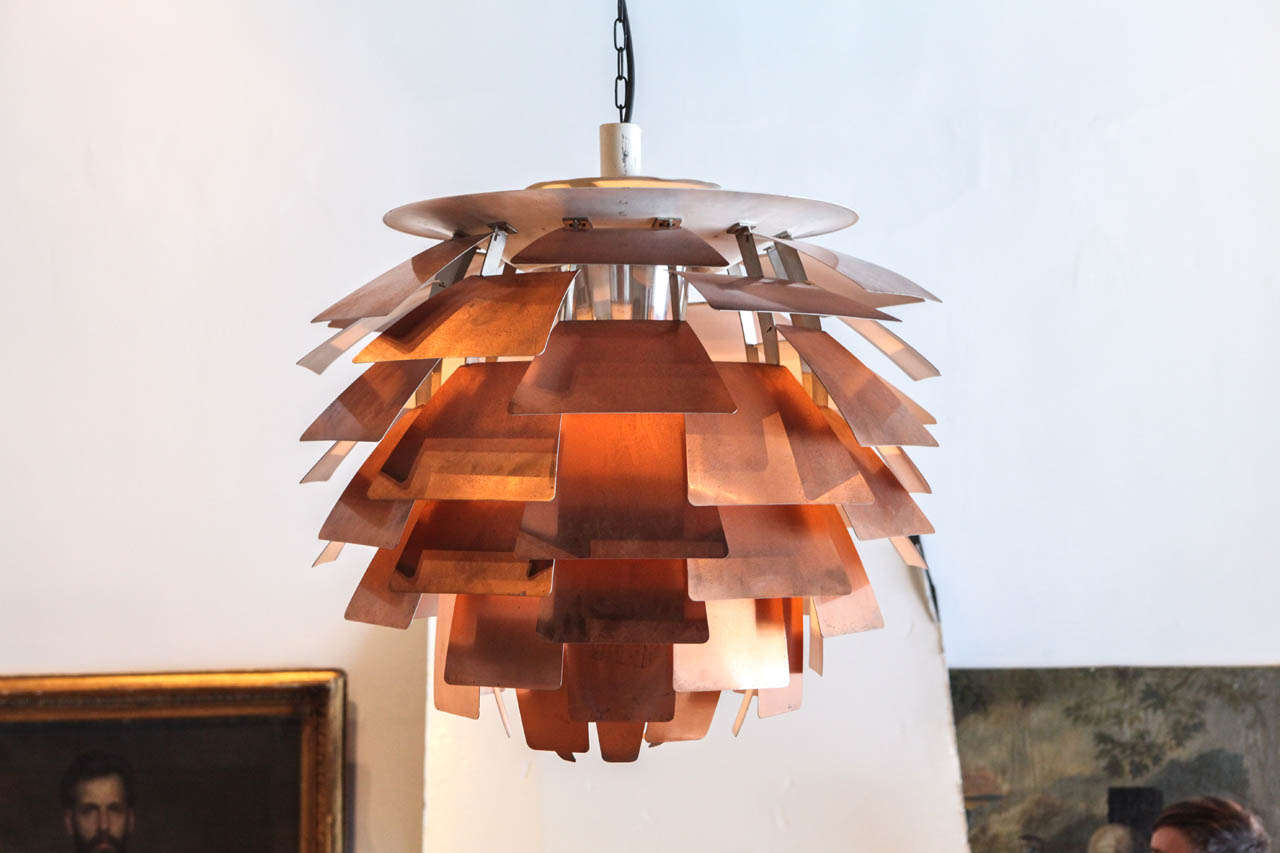the largest size produced in his infamous copper finish , this henningsen artichoke has the most beautiful patinated age throughout. produced by louis poulsen.
