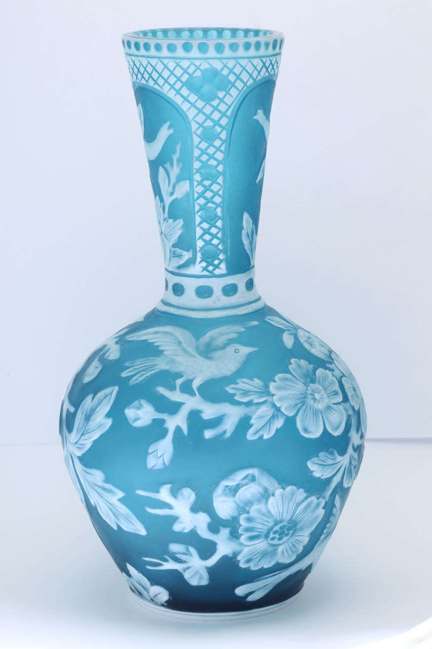 A fine unmarked Stevens and Williams cameo glass vase attributed to Joshua Hodgetts and carved with three birds and flowers on the lower section and insects in the neck