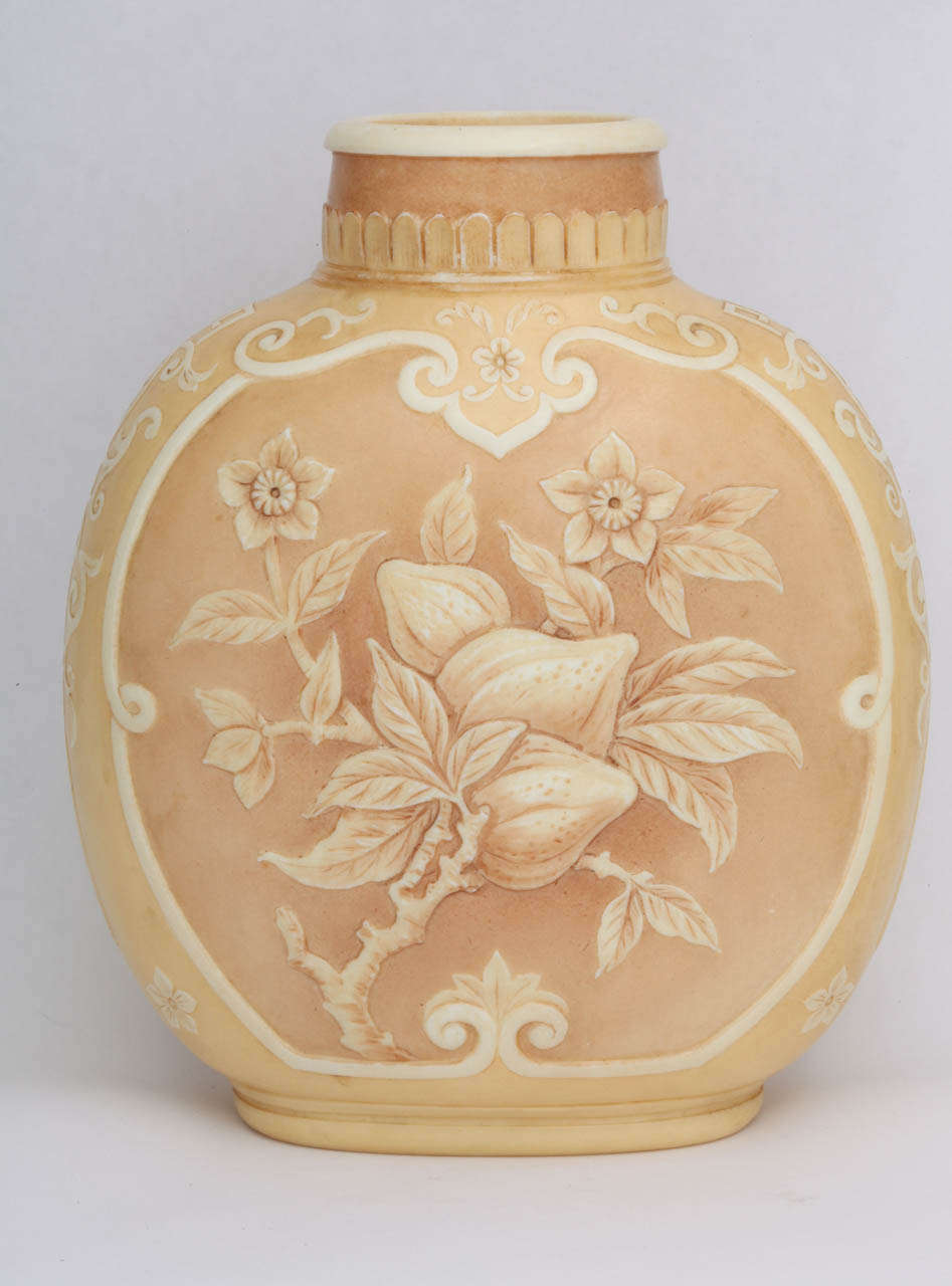 A rare signed Thomas Webb & Sons ivory cameo glass vase beautifully carved with fruit and flowers on the front and back and a geometric pattern on the sides,  the background stained in tan and light brown, signed Thomas Webb & Sons