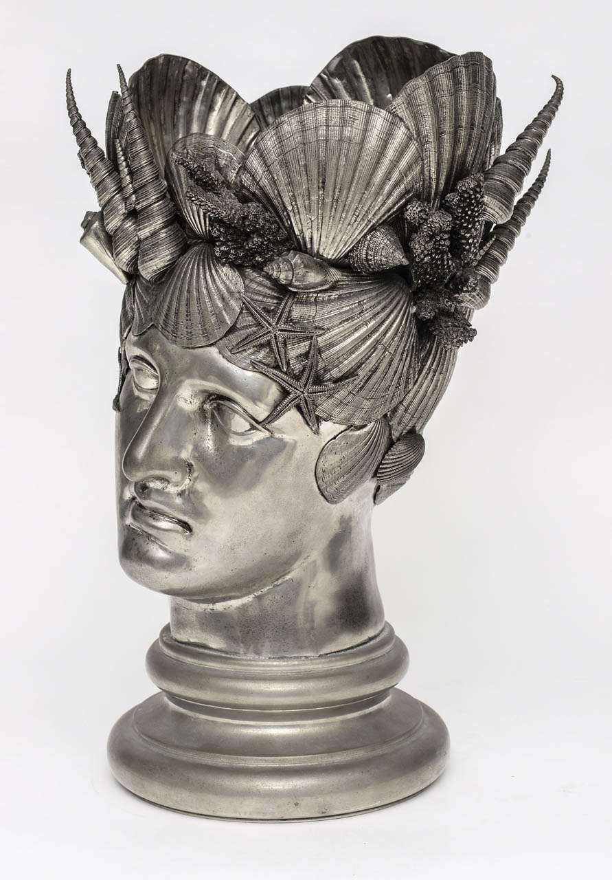 Incredibly ornate and impressive assemblage of handcrafted pewter seashells arranged as a headdress on a bust of Neptune.  This would make an outstanding centerpiece but can also function as a wine or champagne cooler.
The bottom is engraved