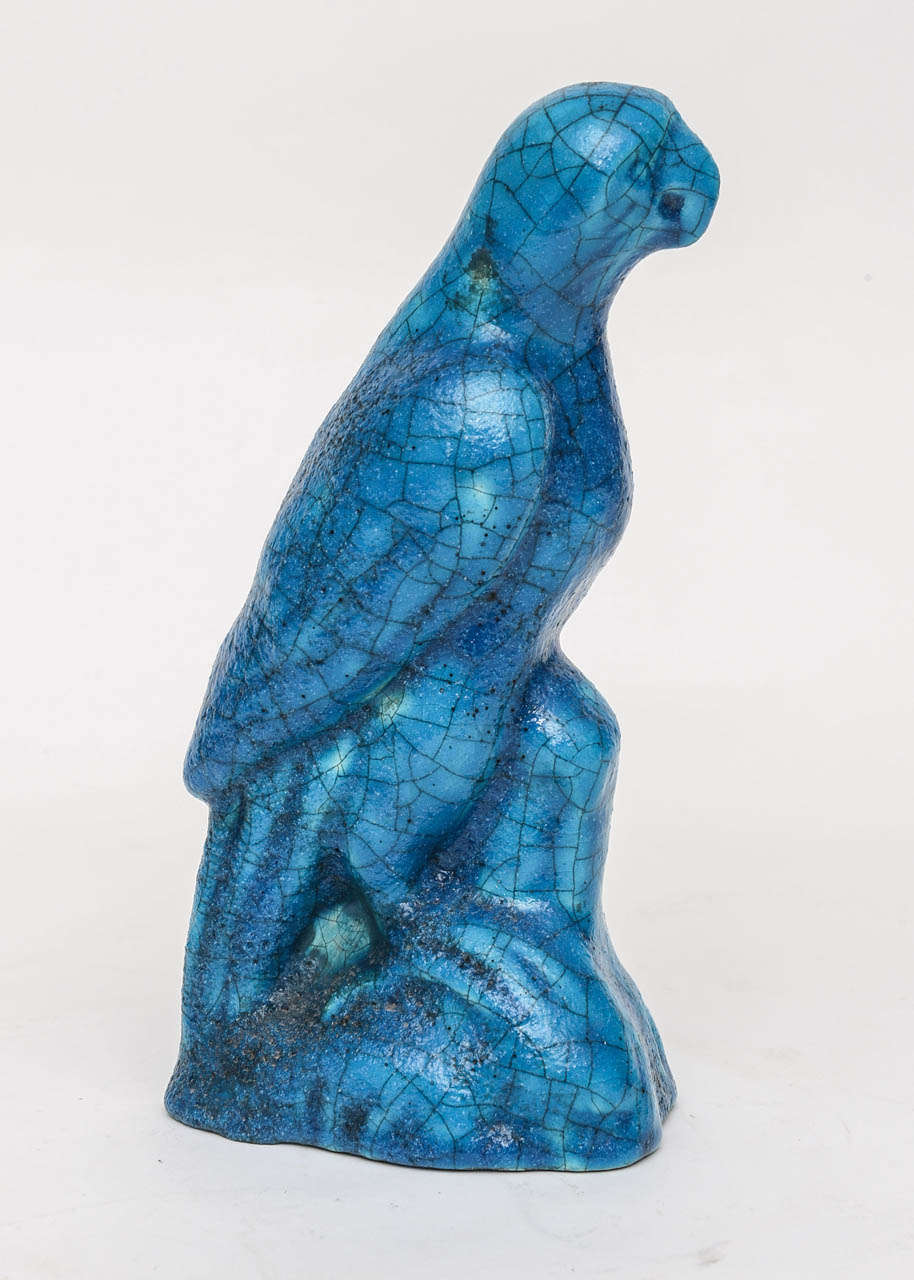 This rare statuette of a parrot in turquoise blue faience glaze was produced by Edmond Lachenal (1855 - 1930).  He was a French potter who produced many porcelain and earthenware vases, statuettes and artworks in the Art Nouveau style.  Rodin was