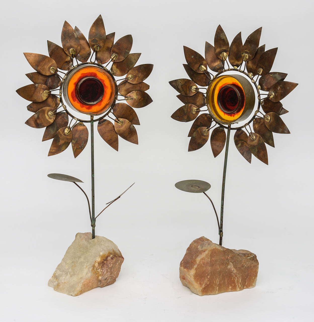 Unique and rare pair of brass and resin sunflowers by Curtis Jere, the California sculptor and designer.  Signed C. Jere 1968 on each of the pair of flowers.  The resin allows light to shine through and glow a brilliant orange color.